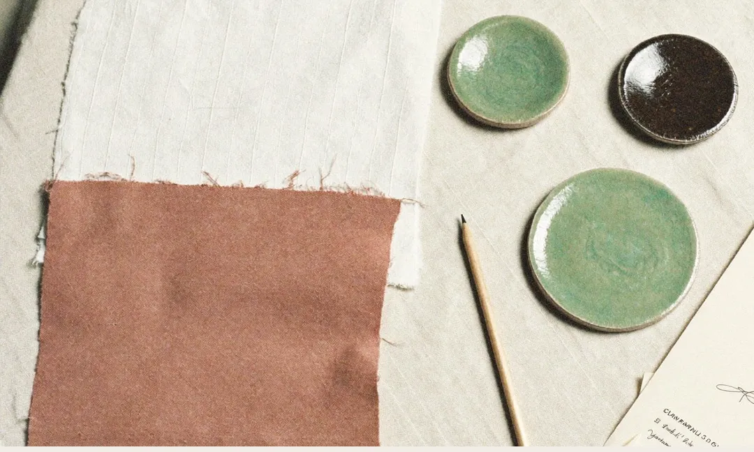 Linen and terracotta swatches beside sage green ceramic plates: a 60-30-10 palette